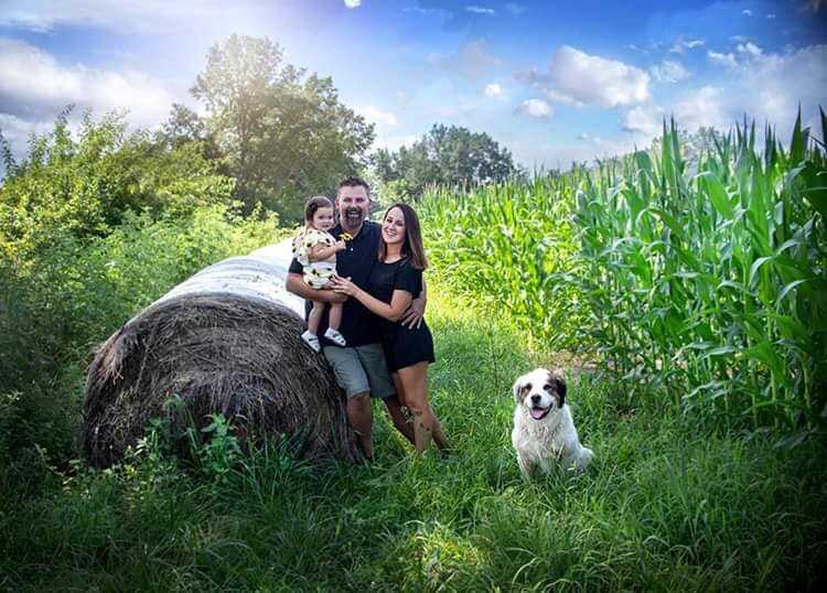 Picture of Kolette Sisk, a rural mail carrier from Missouri and her family with dog