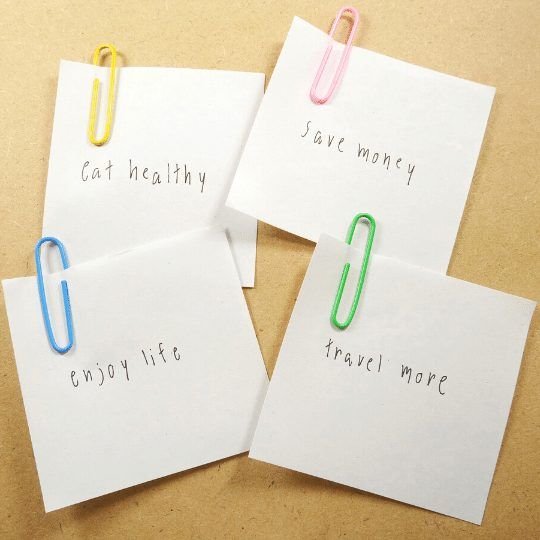 Paperclips holding notes that have goals for the new year