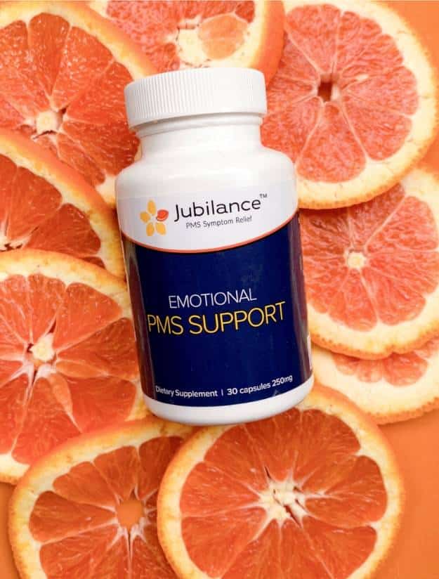 Jubilance PMS Symptom Relief Bottle on Orange Slices