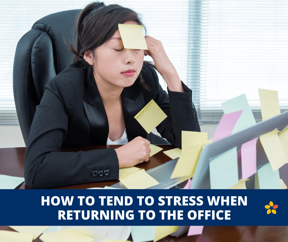 A woman sits at her office desk with post its all over her desk and face embodying the stress of returning to the office.