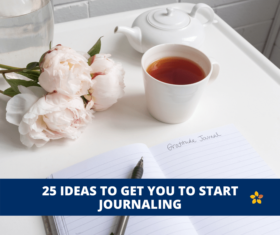 A cup of tea with some peonies next to a journal.