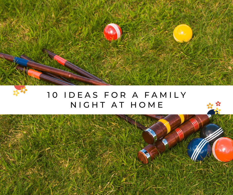 A croquet set sits in the grass as an idea for a family night at home during the summer.