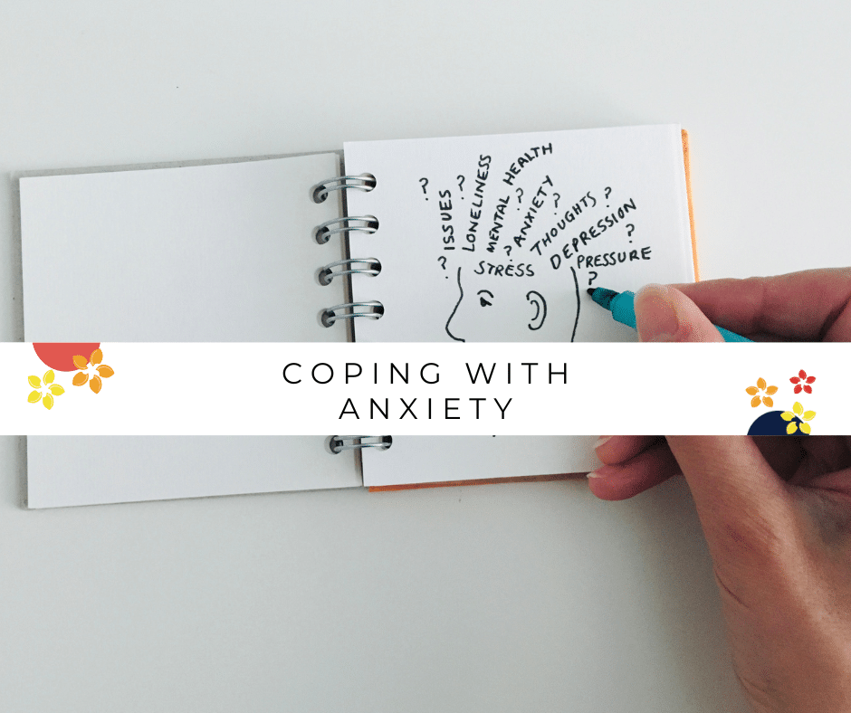 A woman doodles a head with words like anxiety coming out of it as a way to cope with anxiety